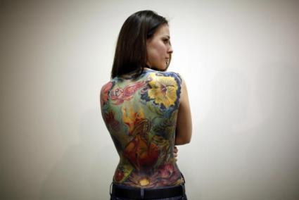 227679-a-woman-displays-her-tattoo-during-an-international-tattoo-exhibition-